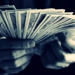 Hands holding cash - image by rawpixel on Freepik