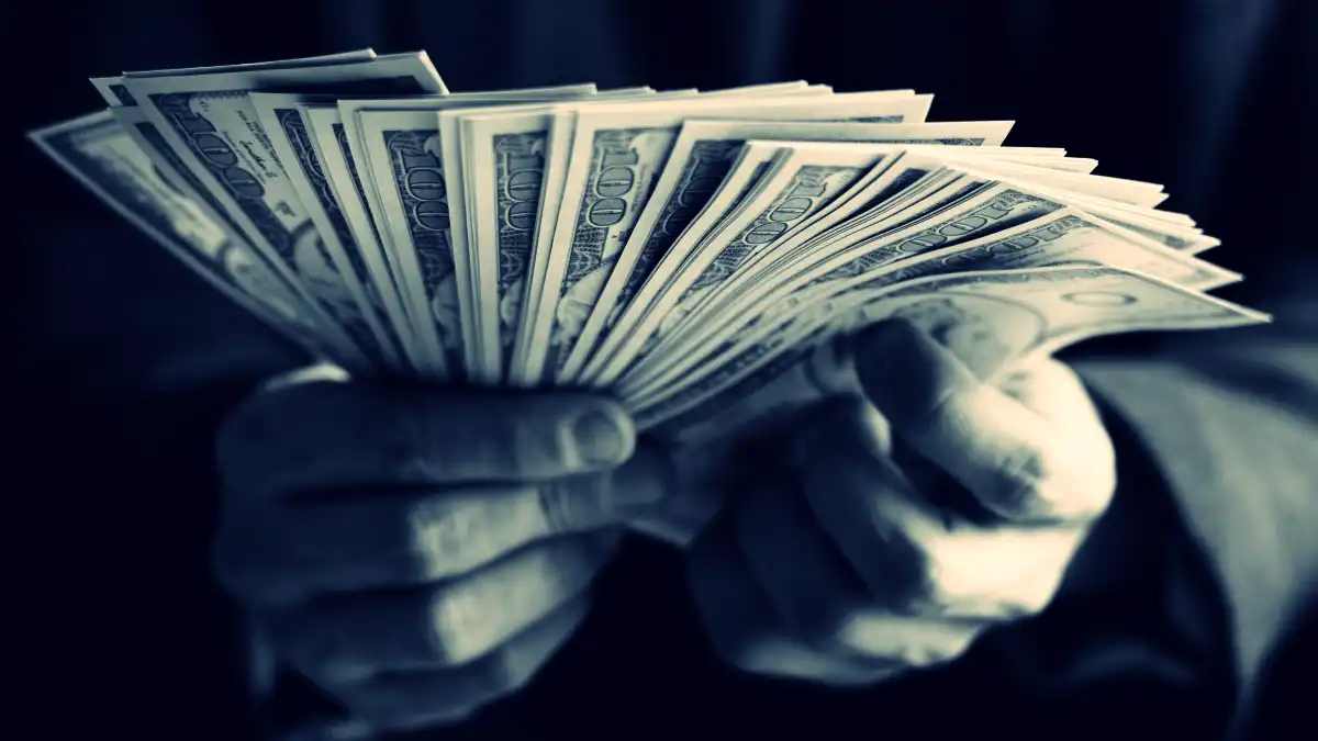 Hands holding cash - image by rawpixel on Freepik